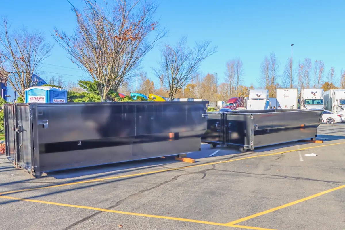 Professional dumpster rental service with roll-off container on residential driveway in Greene